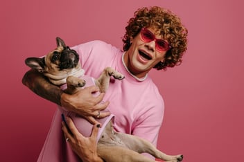 Guy in pink t-shirt holding a cat